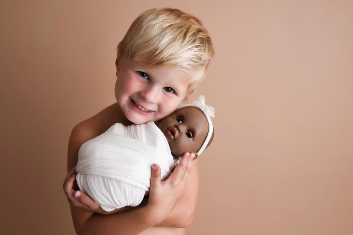 Young Boy Goes Viral After He Asks His Mom to Take Photos of Him and His Baby Doll 'Three'