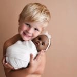 Young Boy Goes Viral After He Asks His Mom to Take Photos of Him and His Favorite Baby Doll 'Three'