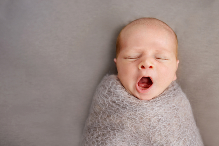 yawning baby taking a nap