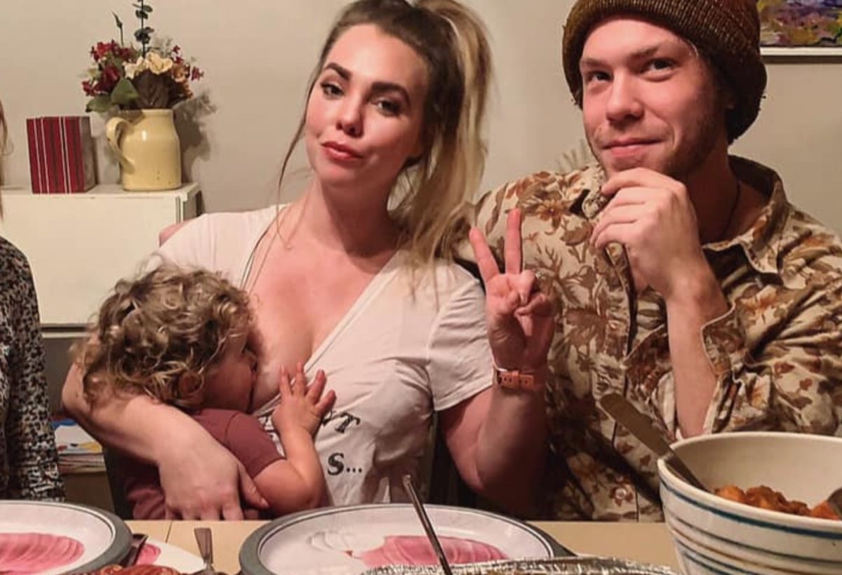 Mom Shares Photo of Her Breastfeeding Daughter at the Thanksgiving Table, Encouraging Other Breastfeeding Moms to Not Be Discouraged