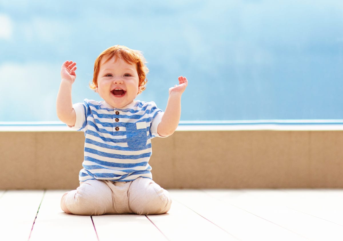 Red haired boy with hands in air 30 Irish-Inspired Baby Names for Boys and Girls