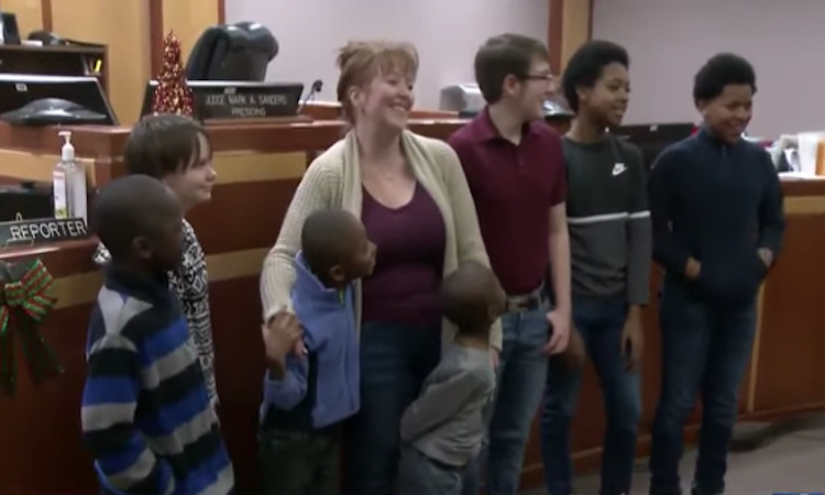 a former foster child adopted 6 boys, she feels it's her 'purpose' and is ready for more