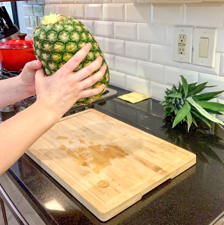 no-knife pineapple hack pounding pineapple on the bottom