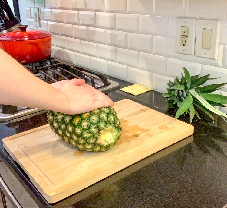 no-knife pineapple hack rolling the pineapple on side