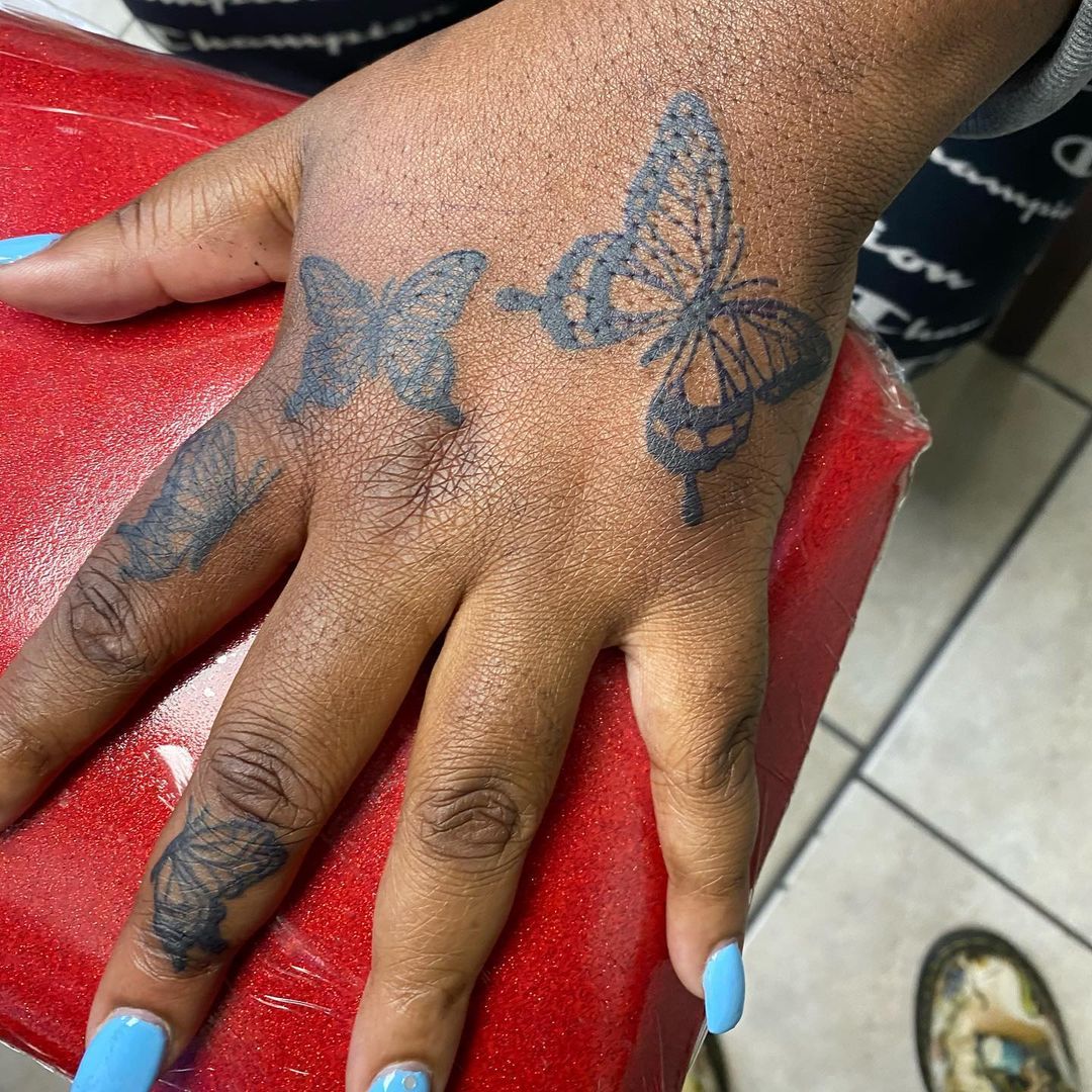 Butterfly Tattoo on Black Skin Hand