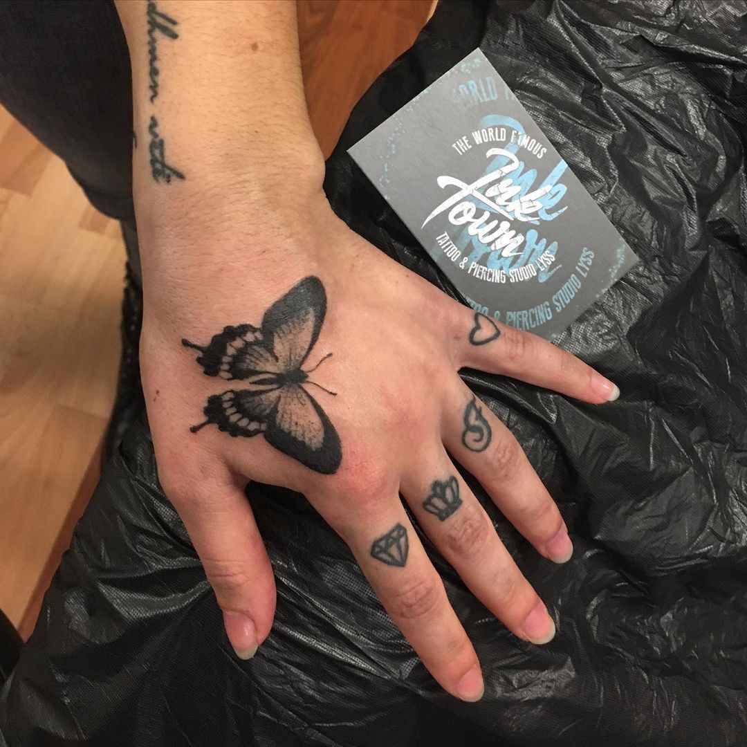 55 butterfly hand tattoo