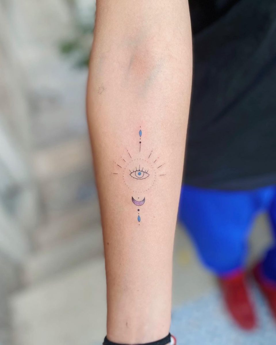 Fine line evil eye tattoo on the wrist