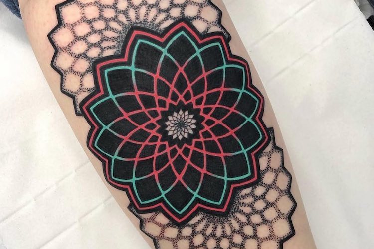 This sacred geometry mandala tattoo uses an elegant color palette and  subtle textures to give the design visual appeal | Ratta Tattoo