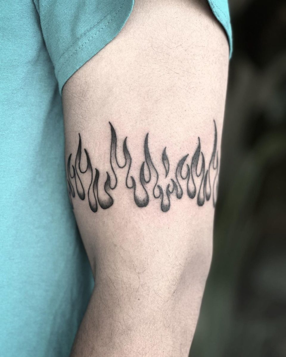 Minimalistic style fire tattoo located on the finger.