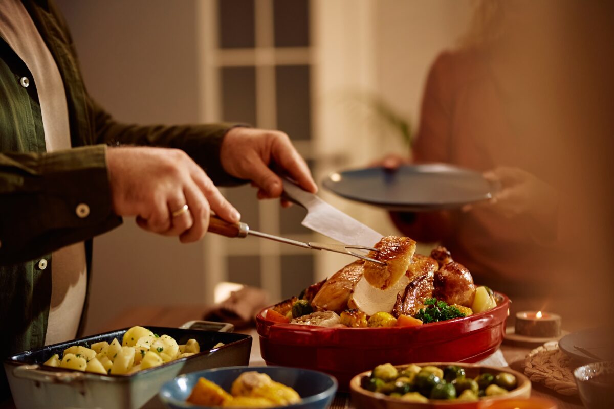 chef cutting turkey into bits