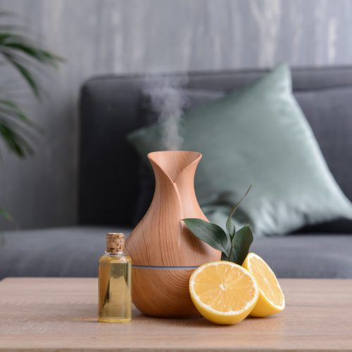 Aroma,Oil,Diffuser,And,Citrus,Fruit,On,Table,In,Room